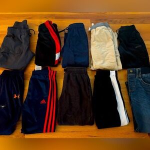 10 pair of boys pants and jeans. under armour; addidas; and other brands